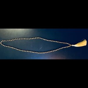 Gold bead necklace with tassel